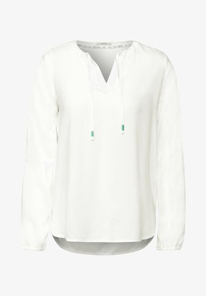 Blouse blanche à manches longues avec un col en V et un détail à cordon. Fabriquée en tissu lisse, avec des manches froncées et un ourlet arrondi.