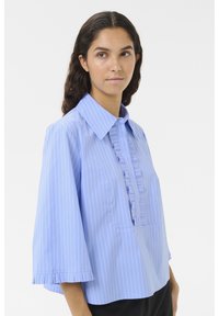 Light blue shirt with vertical white stripes, a pointed collar, pleated front design, and flared three-quarter sleeves with ruffled cuffs.