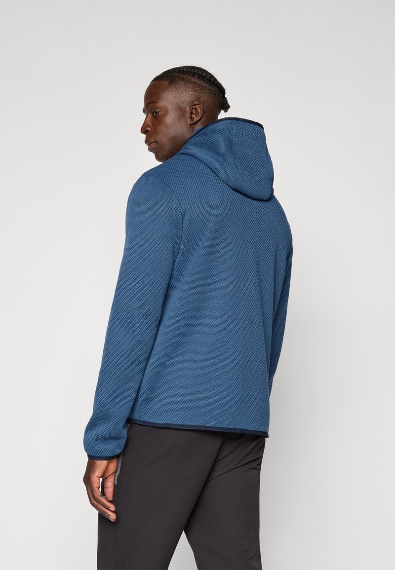 Blau strukturierte Kapuzenjacke mit einer Kapuze, die ein diagonales Streifenmuster aufweist, lange Ärmel und eine lockere Passform hat. Angepasster Rundhalsausschnitt und Bündchen.