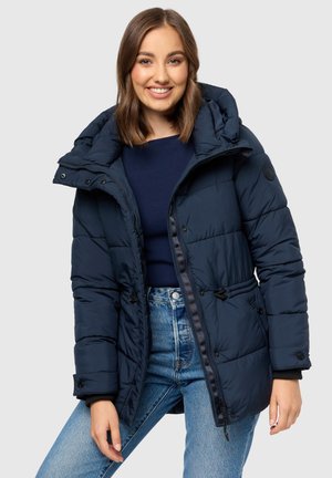 Navy blue puffer jacket with a hood, featuring a zippered front, snap buttons, and drawstring waist. Soft, quilted texture and visible stitching.