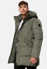 Padded olive green jacket with a hood, featuring a zip closure, side pockets, and a textured fabric in a rectangular quilted design.