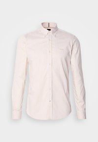 Chemise homme manches longues à rayures verticales beige et blanches, col boutonné et petit logo brodé sur la poitrine.