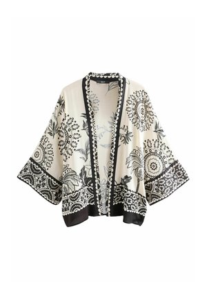 Veste style kimono en noir et blanc avec des motifs floraux et paisley, manches courtes, à l'avant ouvert, et bordure décorative le long des bords.