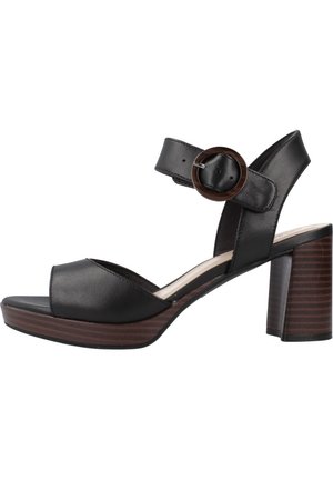 Czarne skórzane sandały na obcasie z otwartym noskiem, szerokim paskiem i regulowanym paskiem na kostkę z okrągłą klamrą, na drewnianym obcasie blokowym.