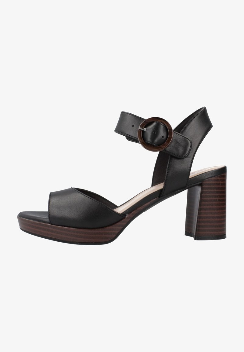 Sandales à talon en cuir noir avec bout ouvert, large bride et bride de cheville ajustable avec une boucle ronde, sur un talon bloc en bois.