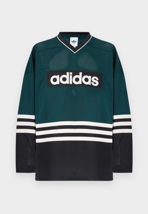 Grön och svart Adidas-tröja med V-ringning, långa ärmar, nätstruktur och en tydlig vit logotyp över bröstet med randiga detaljer.