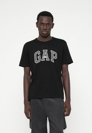 Black cotton t-shirt featuring the word "GAP" in bold, white, outlined letters; short sleeves and a crew neck design.