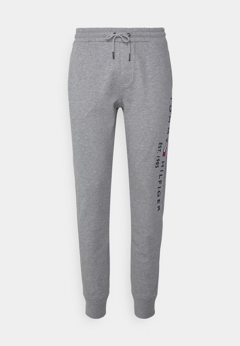 Calças de moletom cinzentas feitas de algodão macio, com uma cintura elástica e cordão, punhos ajustados e branding impresso na lateral.