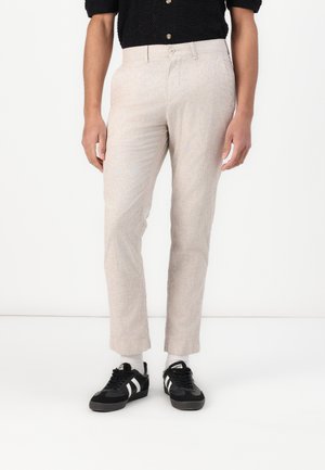 Pantalons beige clair en tissu texturé, avec une coupe droite, deux poches avant et une fermeture à un bouton.
