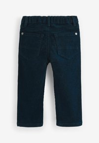 Pantaloni in corduroy blu scuro con una texture a costine, dotati di una cintura elastica, due tasche posteriori e dettagli cuciti.