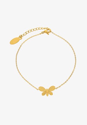 Hieno kultainen ketjurannekoru, jossa keskellä on kuvioitu perhoskoru ja säädettävä lukko, jossa on ovaalinen merkki.