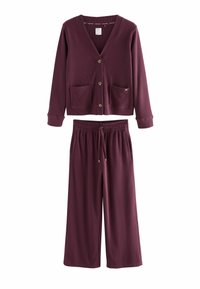 Burgundy knit loungewear set featuring a button-up cardigan with two front pockets and wide-leg pants with an elastic waistband and drawstring.