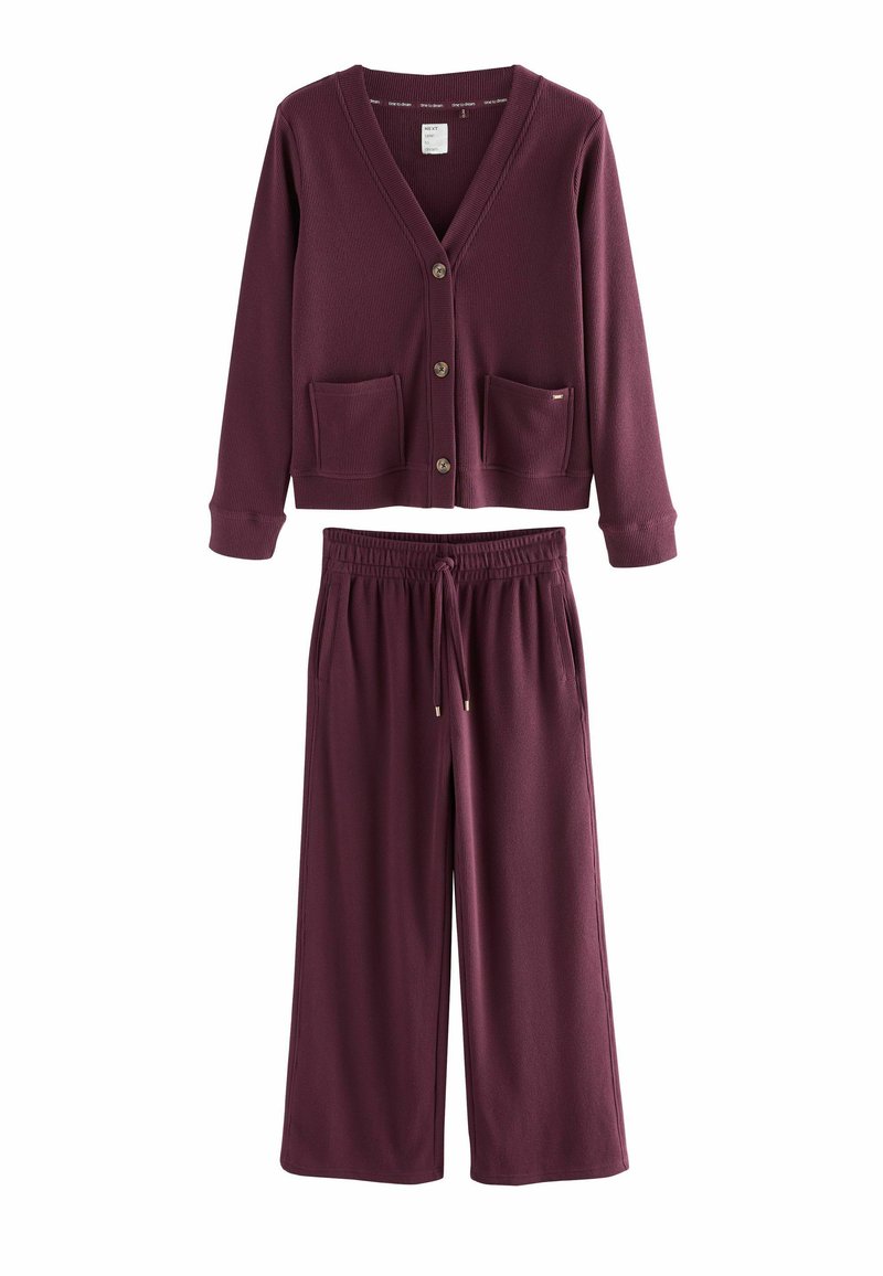 Burgundy knit loungewear set featuring a button-up cardigan with two front pockets and wide-leg pants with an elastic waistband and drawstring.
