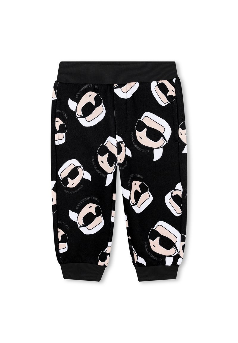Pantaloni della tuta neri con facce di cartoni animati stampate che indossano occhiali da sole; presentano una cintura elastica e polsini, realizzati in un tessuto morbido.