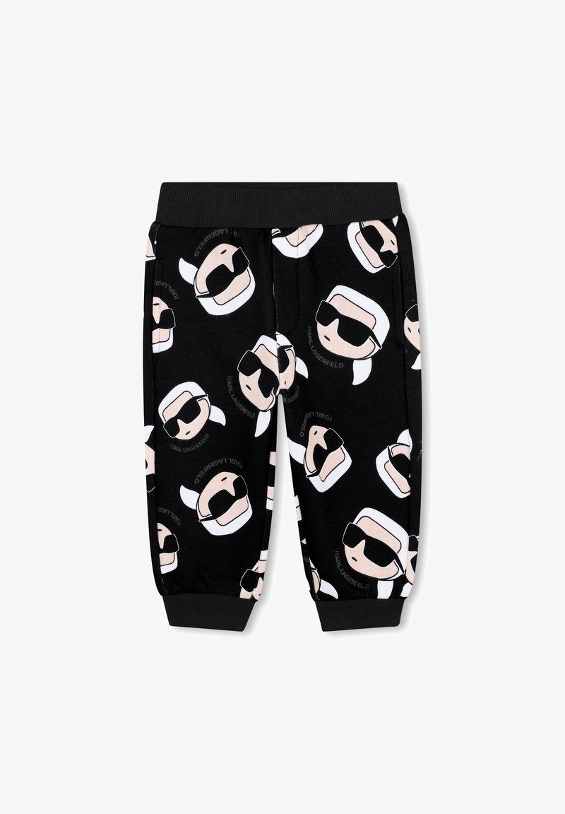 Pantaloni della tuta neri con facce di cartoni animati stampate che indossano occhiali da sole; presentano una cintura elastica e polsini, realizzati in un tessuto morbido.