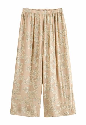 Pantalons larges beiges avec un motif floral doré, taille élastique et texture de tissu lisse, adaptés pour un usage décontracté.