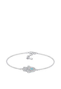 Silver kedja armband med en hamsa hand charm prydd med klara kristaller och en center blå ädelsten, vilket skapar en elegant design.
