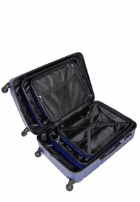 Twarda walizka w ciemnoniebieskim kolorze z wieloma przegrodami. Posiada dwa zamki błyskawiczne, czarne wnętrze i cztery kółka dla lepszej mobilności.