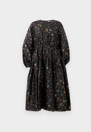 Black floral dress with long sleeves, elastic waistband, and tiered skirt. Features multicolored small floral patterns on a smooth fabric.