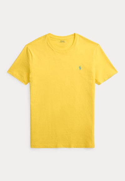 Κίτρινη βαμβακερή μπλούζα με στρογγυλή λαιμόκοψη και κοντά μανίκια. Διαθέτει μικρό μπλε λογότυπο στο αριστερό στήθος. Ομαλή υφή.