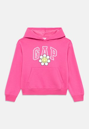 Pink hoodie with a front pocket, featuring a large "GAP" logo and a flower graphic with a smiling face. Made from soft fabric.
