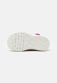 White rubber outsole with textured pattern, featuring pink accents along the edge. Non-slip design ideal for grip and stability.