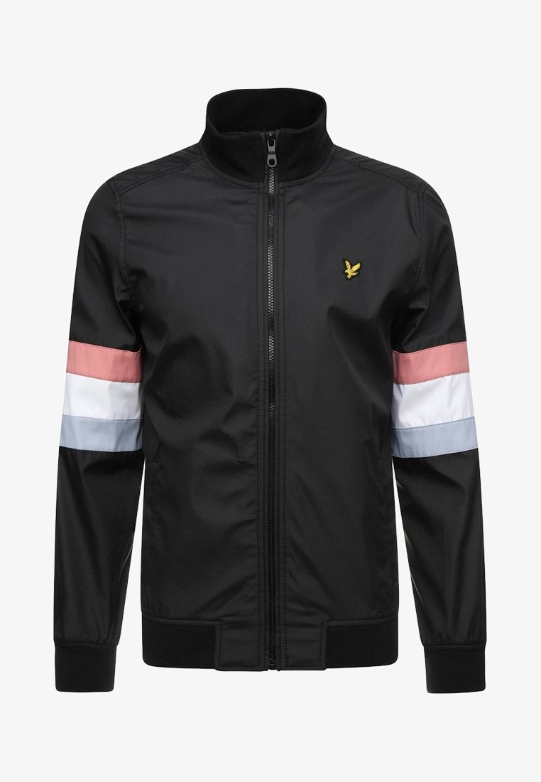 Sort zip-jakke med lyserøde, hvide og lyseblå striber på ærmerne og et lille gult broderet fugl logo på brystet.