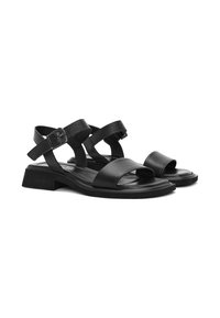 Sandalias de piel negra con múltiples tiras, un tacón robusto, punta abierta y hebillas ajustables para un ajuste seguro. Textura suave en toda su superficie.
