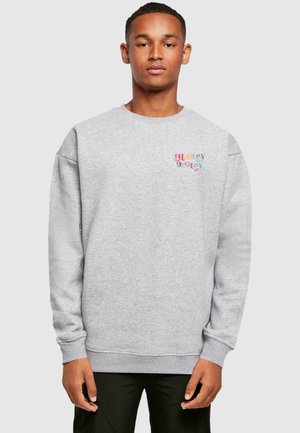 Gray sweatshirt featuring a graphic text design "Holly Jolly" in colorful lettering on the chest. Soft fabric, relaxed fit, ribbed cuffs.