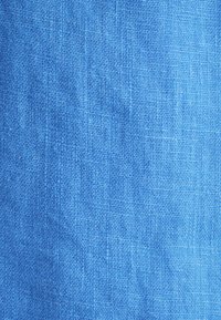 Tessuto di lino blu con una trama testurizzata, caratterizzato da una finitura liscia e un colore uniforme senza motivi o difetti visibili.