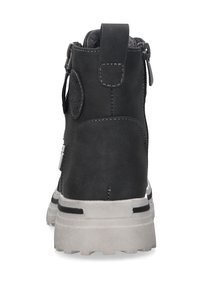 Schwarze Leder-Stiefelette mit strukturierten Oberflächen, einer grauen Gummisohle und einem Reißverschluss an der Seite. Mit einer Schlaufe zum einfachen Anziehen.