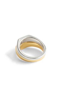 Bague en or et argent en couches avec un design incurvé. Présente une finition métallique lisse et des couleurs contrastées, offrant une esthétique élégante.