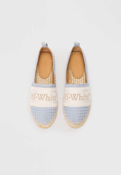 Gaiši zila espadrile ar pinumiem zolēm un ietilpīgiem bezkrāsainiem auduma siksnām, kas pārklāj pirkstus un ir apdrukātas ar "Off-White" gaismas brūnās krāsas burtiem.