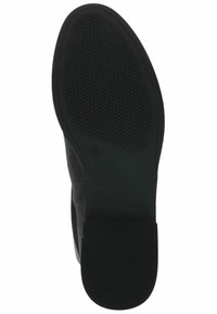 Semelle en caoutchouc noir avec texture antidérapante, dotée d'un dessus lisse noir. Le design est épuré avec un bout rond et un talon modeste.
