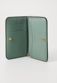 Green leather wallet with multiple card slots and a gold snap closure. Interior features a smooth texture and minimal branding detail.