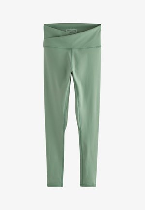 Zöld leggings rugalmas anyagból, széles, hajtható derékpánttal. Simító varrásokkal és sima textúrával rendelkezik.