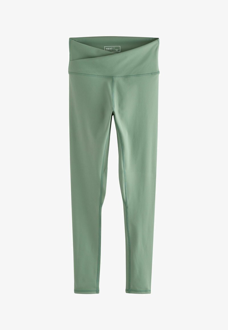 Leggings verts en tissu extensible avec une large ceinture repliable. Dotés de coutures plates et d'une texture lisse.