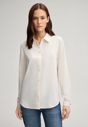 Lange mouwen knoopshirt in off-white, gemaakt van gladde stof met een kraag, voorzien van een ronde zoom en subtiele knoopaccenten.