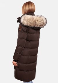 Brown padded coat with a faux fur hood. Features a side pocket and brand patch on the sleeve. Simple design with quilted texture.