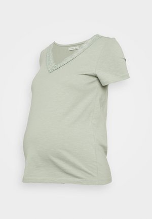 T-shirt de maternidade verde claro com mangas curtas, decote em V e detalhe de renda ao longo da gola. Tecido macio e elástico para conforto.