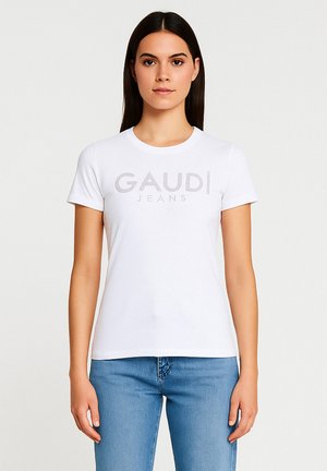 T-shirt bianco a maniche corte realizzato in cotone con scollatura rotonda, dotato di un logo grigio testurizzato "GAUDI JEANS" sulla parte anteriore.