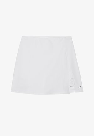White athletic skirt featuring a side slit, smooth fabric texture, and a small black logo accent near the hem.