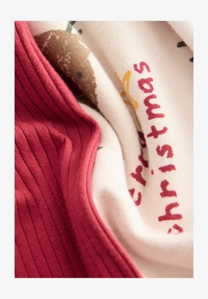 Tessuto ribbed rosso sovrapposto a tessuto crema con un design di riccio marrone e testo rosso che dice "Buon Natale". Texture morbida.