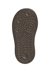 Brun Adidas-sko sula med cirkulära och linjära mönster samt flera inpräglade Adidas trefoil-logotyper på undersidan.