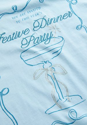 Einladung zur festlichen Dinnerparty mit einem blauen Champagnerglas und silbernem Band auf einem hellblauen Stoffhintergrund.