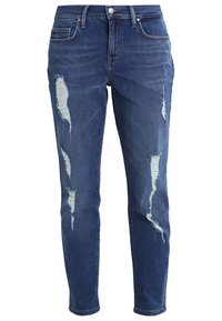 Slim-fit siniset farkut, joissa on kulutettuja kohtia, viisi taskua ja metallipainikekiinnitys. Ominaisuuksiin kuuluu haalistunut pesu ja kapeneva lahje.