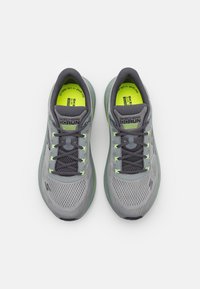 Gray running shoes with mesh upper, lime green accents, and reflective details. Features flat laces and a cushioned sole.