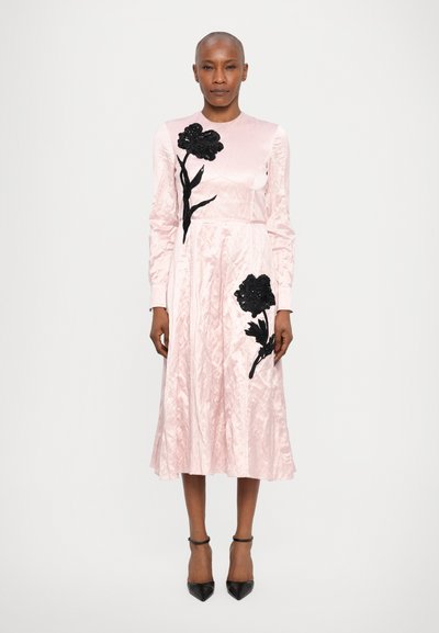 Pink satin dress with long sleeves, featuring black embroidered flower designs. A-line silhouette with a smooth, shiny texture and fitted bodice.