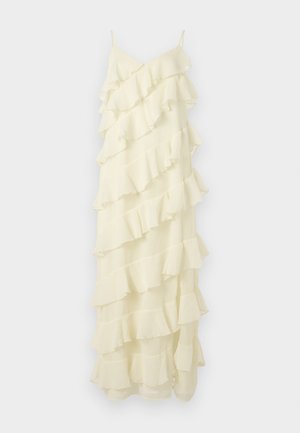 Dlouhé, bez rukávů šaty z měkké, světle žluté látky. Má několik vrstev volánků, které vytvářejí texturu a pohyb. Jednoduché tenké ramínka.