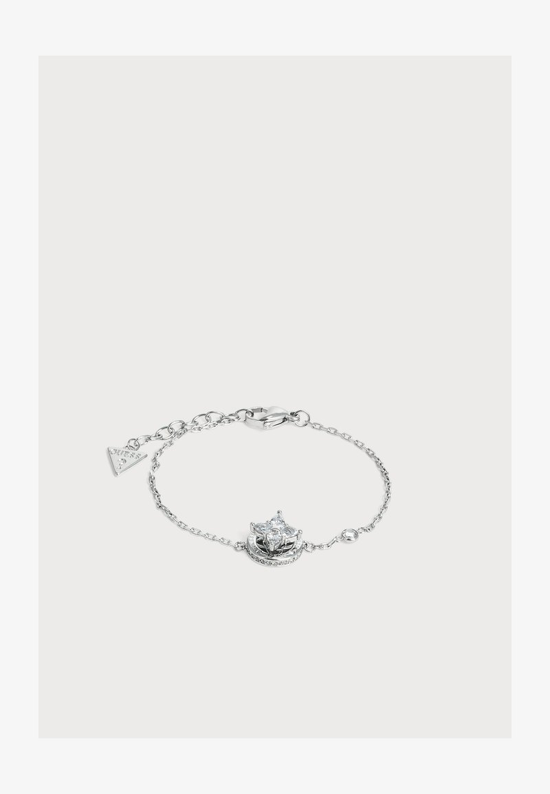 Bracelet chaîne en argent délicat avec un centre en cristal en forme d'étoile ronde et un petit pendentif triangulaire près du fermoir.